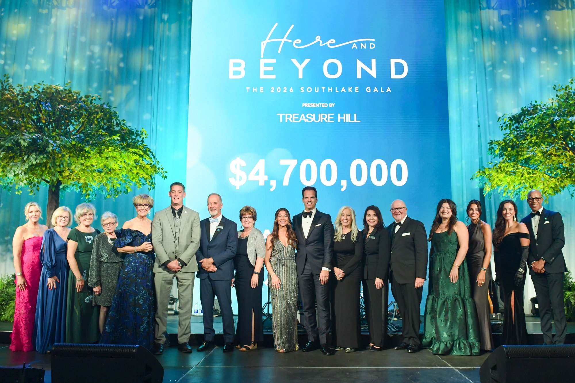 Southlake Gala Steering Committee, sponsors and Southlake leaders on stage in front of a screen announcing $4,700,000 raised at the 2026 Here and Beyond Southlake Gala